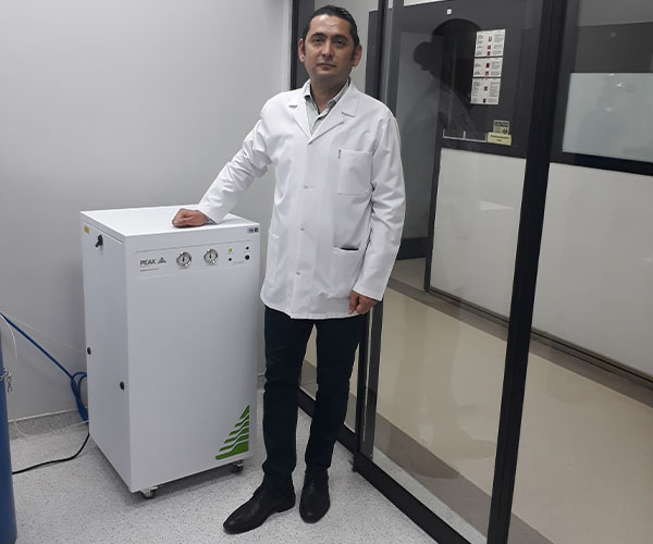 Onursal Saglam standing beside the Infinity XE 5011 Nitrogen gas generator