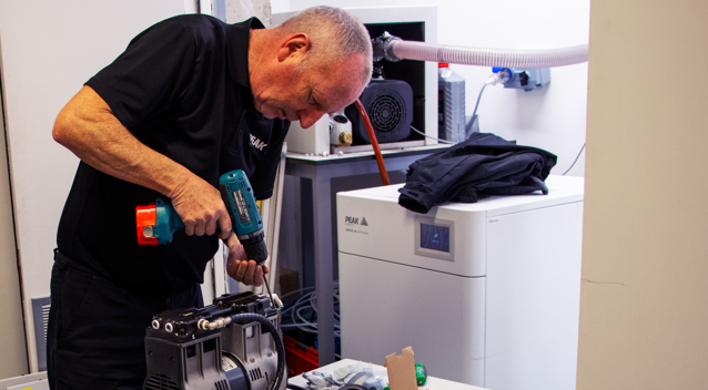 PEAK Scientific engineer maintaining nitrogen gas generator in Belgium