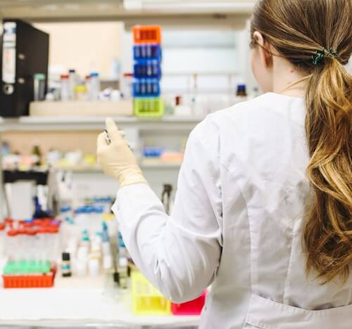 Woman wearing a white lab coat in the lab