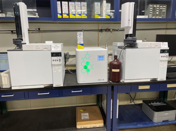 PEAK Precision Hydrogen Trace on a workbench next to Kraton Chemical LLC's GC